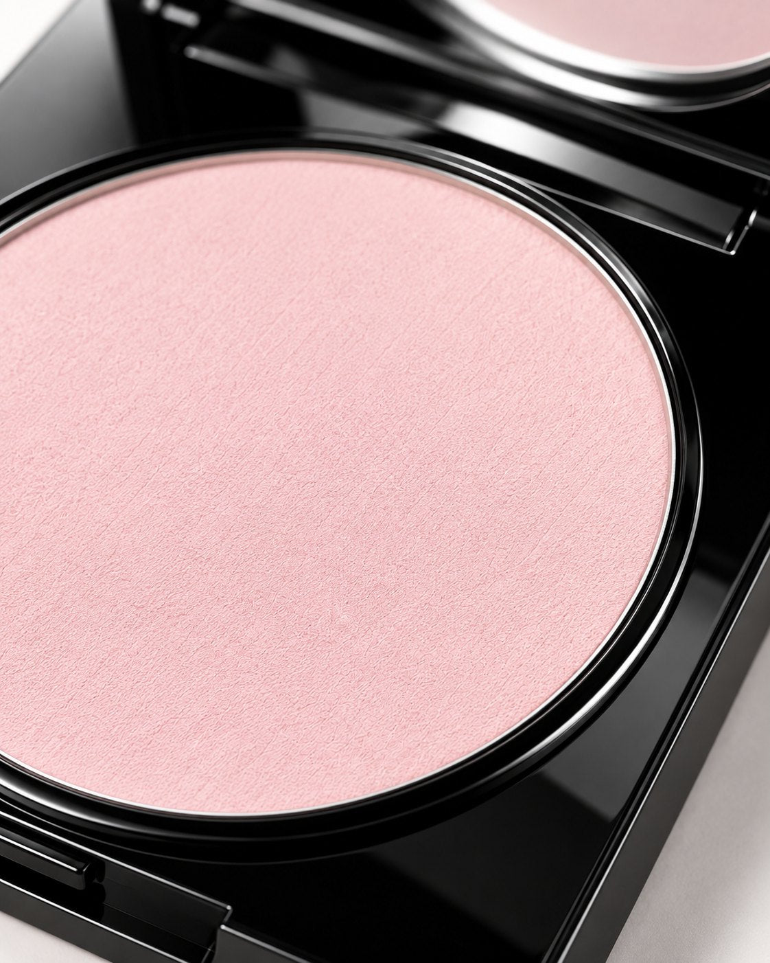 Close-up of Magic Powder Translucent Pastel Pink in its black compact
